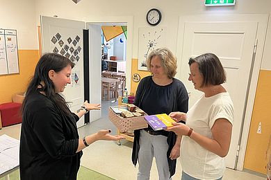 Zum Tag der Kinderbetreuung überreicht die Bereichsleitung der BBW-Kindertagesstätten ein Dankeschön an eine pädagogische Fachkraft